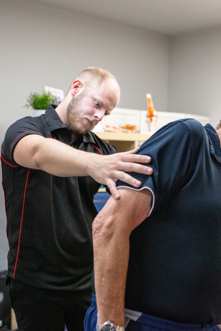 osteopath assesses spine movement in biggleswade