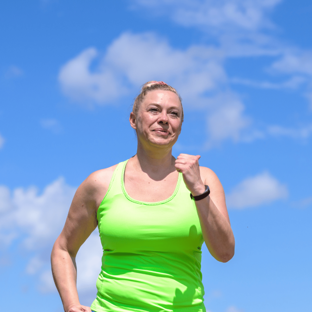 middle aged woman running and smiling