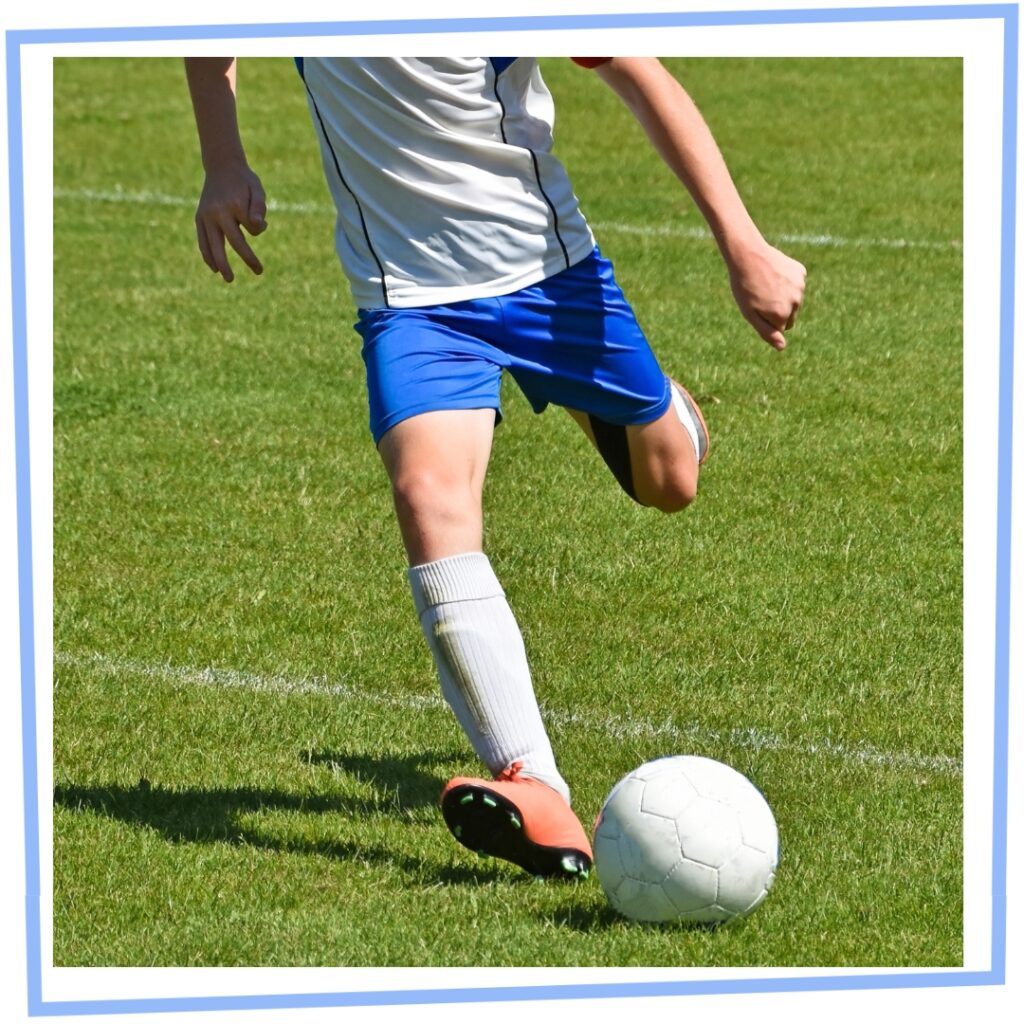 footballer kicks the ball
